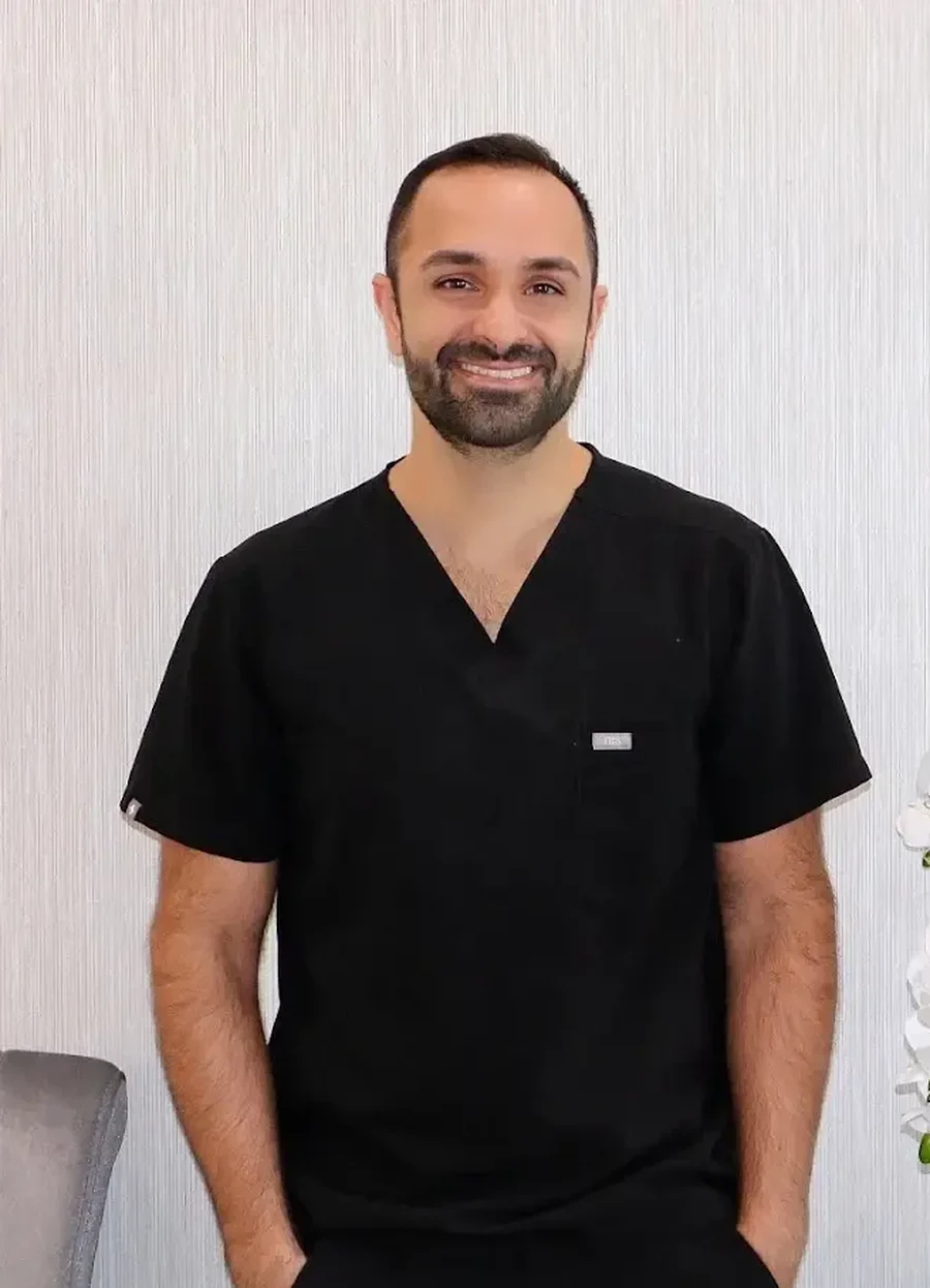 Dr. Edmond Ahdoot standing in black scrubs