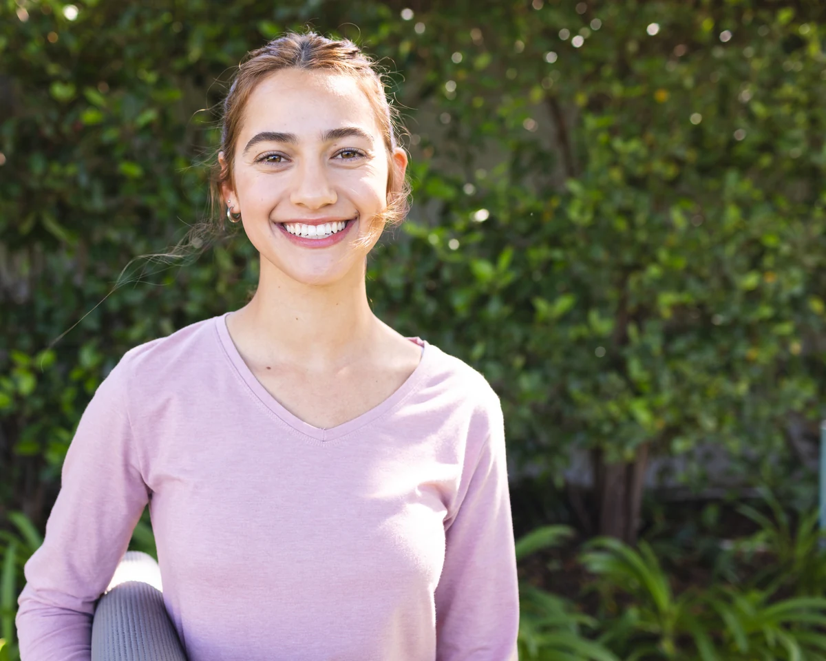 Smiling patient outdoors for Smiles by Eddie financing options
