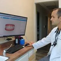 Dr. Edmond Ahdoot reviewing a digital smile preview at a consultation monitor
