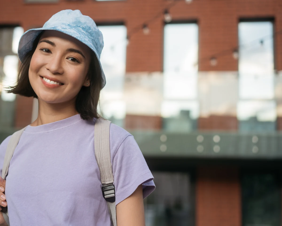 Smiling patient in a blue hat for Preventive Dentistry at Smiles by Eddie